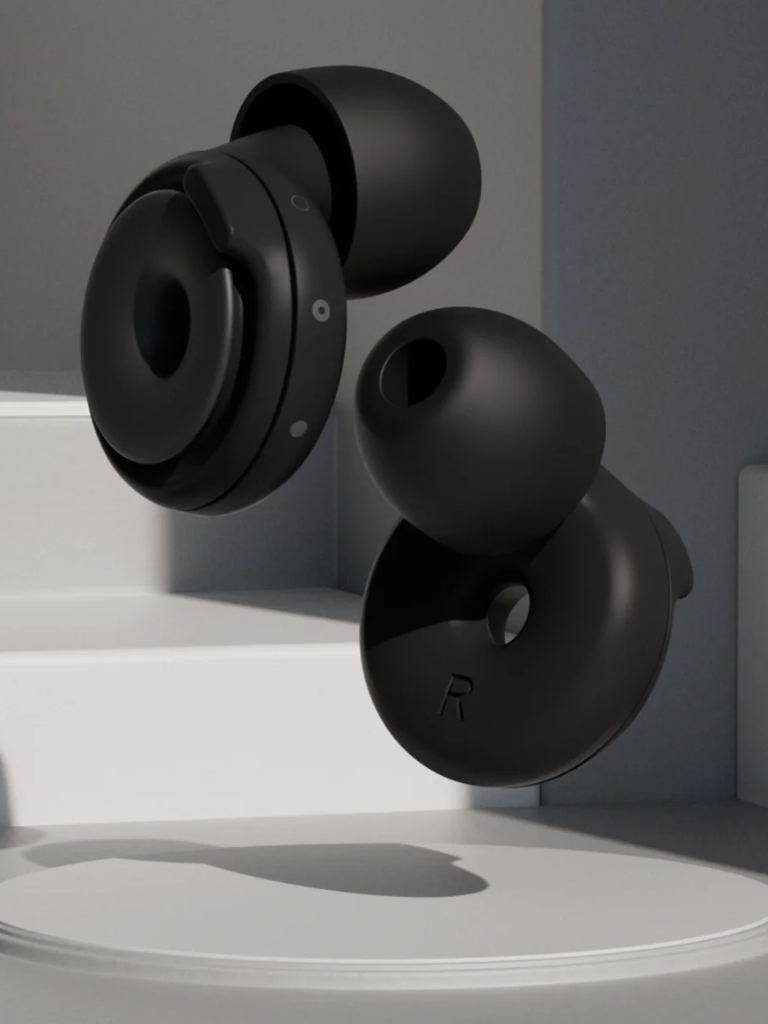 Two black wireless earbuds floating against a minimalist gray background with light and shadow effects, resembling the sleek design of modern massage guns.