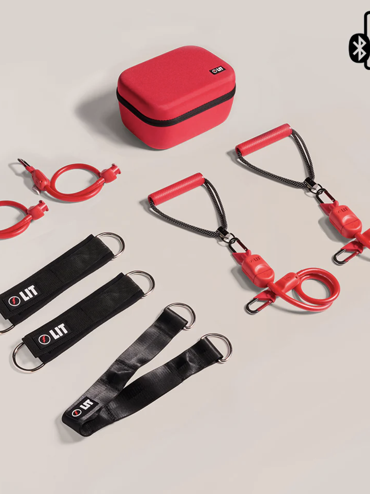 A set of red resistance bands with handles, ankle straps, door anchors, and a red carrying case. A Bluetooth icon is also visible in the top right corner. Perfect for pairing with massage guns to optimize your recovery routine.